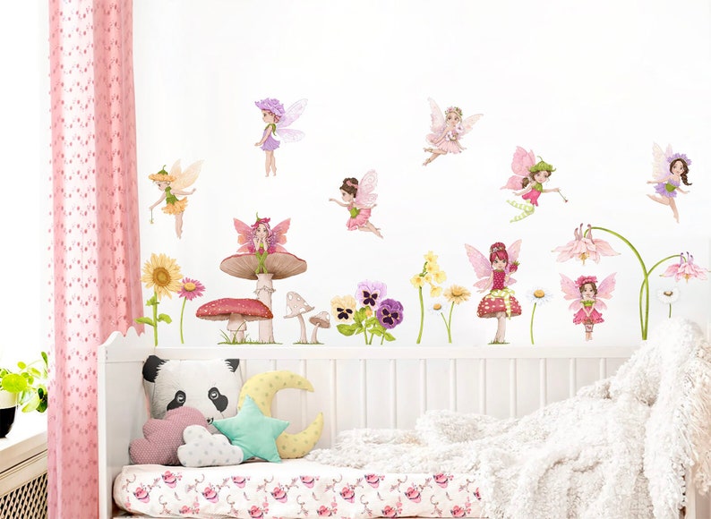 May include: A whimsical wall decal set featuring fairies, flowers, and mushrooms in soft pastel colors. The fairies have delicate wings and are depicted in various poses. The set includes sunflowers, daisies, and pansies, creating a magical, fairytale theme.