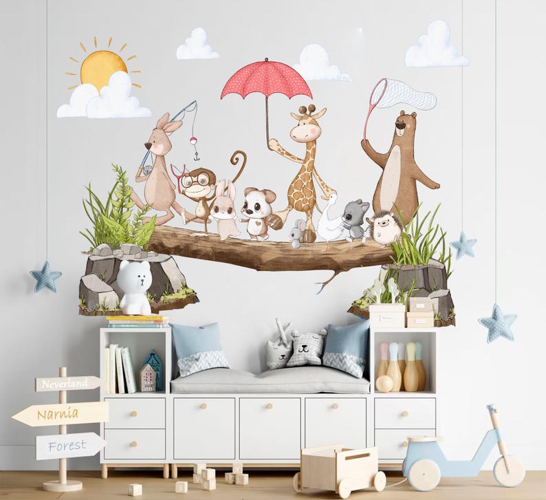 May include: A white wooden bench with a light blue cushion and a white wooden shelf underneath. The shelf is filled with books and a small wooden house. The wall behind the bench is decorated with a whimsical woodland scene featuring a red umbrella, a giraffe, a kangaroo, a monkey, a fox, a hedgehog, and a bear. The wall also has a sign with the words "Neverland", "Narnia", and "Forest".