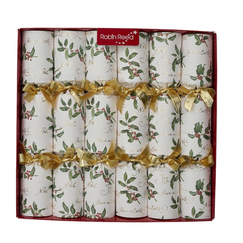 May include: A box of Christmas crackers with a festive design. Each cracker is white with a holly and berry pattern, gold text, and tied with a gold ribbon. The box has the text "Robin Reed" on it.
