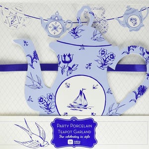 May include: A blue and white teapot garland with a sailboat design. The garland is made of cardboard and has a blue ribbon attached. The text "Party Porcelain Teapot Garland For celebrating in style Talking Tables" is printed on the bottom of the image.
