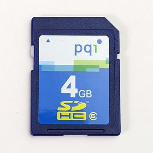 May include: A blue PQI brand 4GB SDHC memory card with a white label featuring green and blue rectangular accents. The card displays the text 4GB, the SDHC logo in yellow, and a small number six inside a circle on the bottom right corner.