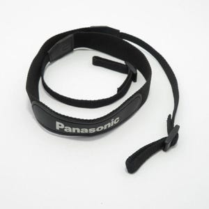 May include: A black camera neck strap made of woven nylon webbing featuring a padded section with the white text Panasonic printed on the front. The strap includes adjustable plastic buckles and thin attachment loops at both ends for a camera.
