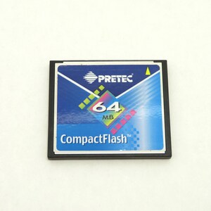 May include: A CompactFlash memory card with a blue and white label. The label features the brand name "PRETEC", the capacity "64 MB", and the words "CompactFlash". The card has a black frame.