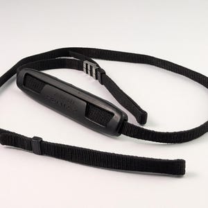 May include: Black camera strap with the text "ASAHI PENTAX" on the shoulder pad. The strap is made of woven nylon and features adjustable buckles for length adjustment. The strap is designed to be attached to a camera.