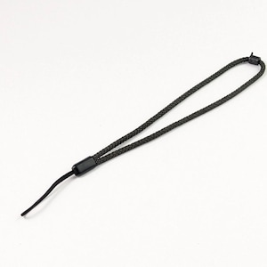 May include: A black wrist strap with a braided design. The strap has a loop at one end and a small, solid black plastic piece at the other end. The strap is designed to be worn around the wrist.