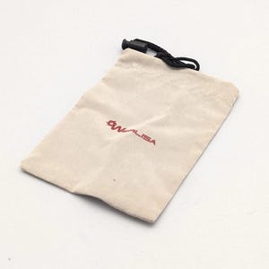 May include: A rectangular, off-white fabric drawstring pouch featuring a black cord with a plastic toggle closure. The front of the pouch displays the red text WALISA accompanied by a small, stylized red circular logo above the brand name.