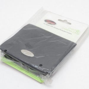 May include: A black digital camera case in a clear plastic package. The case has a silver oval emblem and is labeled "DIGITAL CAMERA CASE" on the packaging. The case is designed for standard formatted cameras.