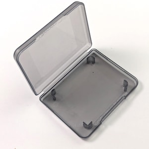 May include: A clear, grey plastic rectangular box with a hinged lid. The lid is open, revealing the interior. The box has rounded corners and is set against a white background.