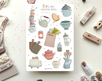 May include: A sheet of stickers featuring illustrations of kitchen accessories in a pastel color palette. The stickers include a stack of teacups, a teapot, a casserole dish, a mixing bowl, a cutting board, a loaf of bread, a jar of spices, a french press, a toaster, a mortar and pestle, a pitcher, and a pair of oven mitts. The text "Kitchen Accessories Stickers" is at the top of the sheet.