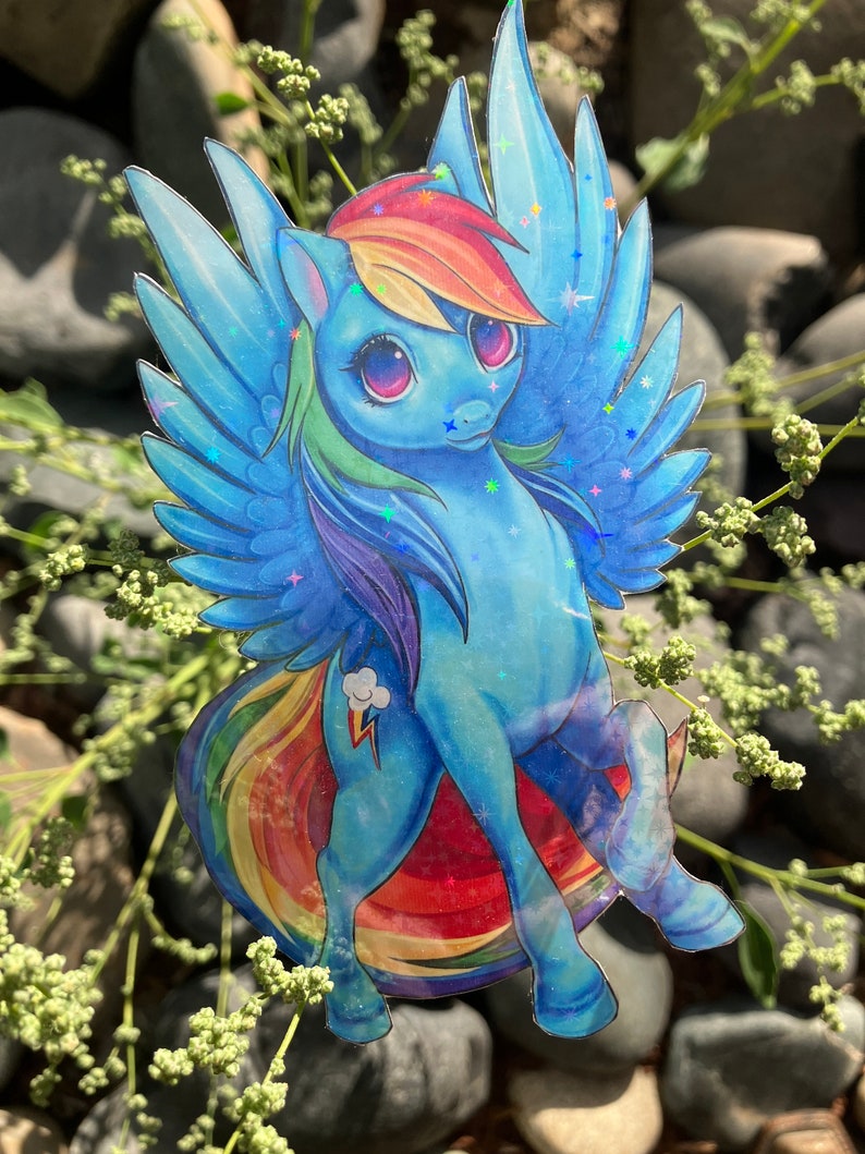 May include: A blue and rainbow-colored cartoon pony with a lightning bolt and cloud symbol on its flank. The pony has large, pink eyes and a rainbow mane and tail. The pony is depicted with wings and is flying.