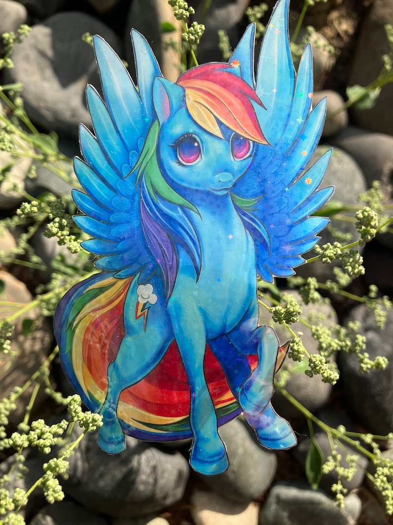May include: A blue and rainbow iridescent sticker of a cartoon pony with wings and a rainbow mane and tail. The pony has a lightning bolt cutie mark on its flank.