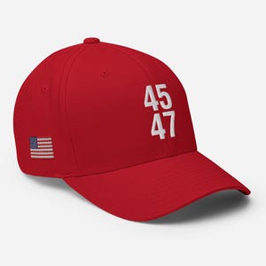 May include: Red baseball cap with a white American flag patch and the numbers "45 47" embroidered on the front.