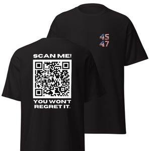 May include: Black t-shirt with a QR code and the text "SCAN ME! YOU WON'T REGRET IT." on the back. The front of the shirt has the numbers "45 47" with an American flag design.