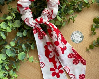 Red floral scrunchie with polka dot flowers with detachable tail.