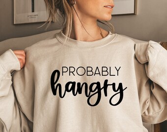 May include: A beige sweatshirt with the text "PROBABLY hangry" printed in black.