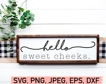 May include: A wooden sign with a white background and a brown frame. The sign says "hello sweet cheeks."