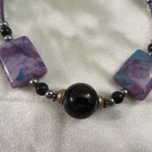 Purple stones and seed beads with black repurposed beads neckless