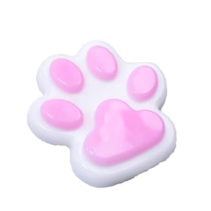 May include: A white and pink paw-shaped object. The paw has five pink pads on a white base. The pads are oval-shaped, and the largest pad is heart-shaped. The object is likely a decorative item or accessory.