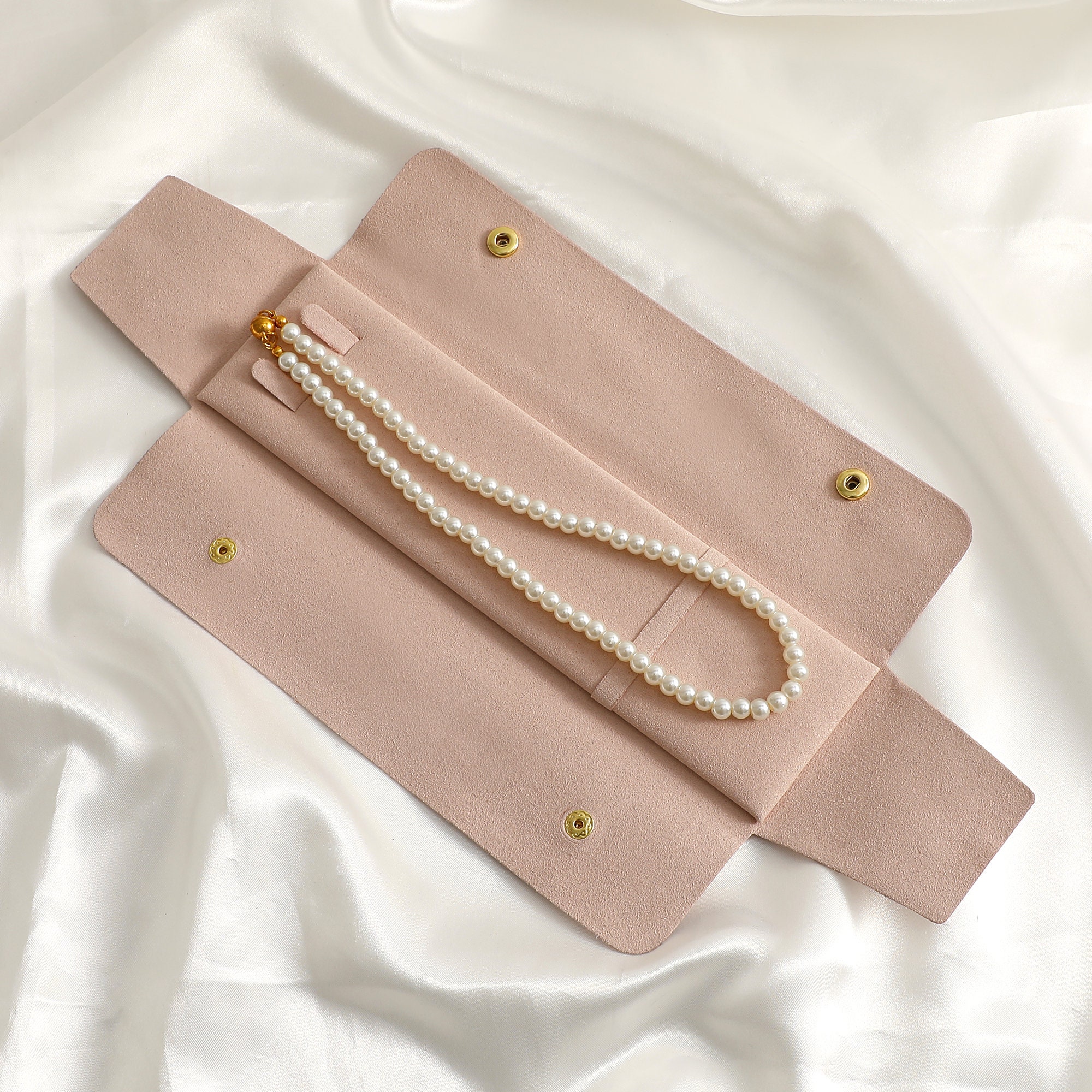 Custom logo microfiber bag with gold snap closure, demonstrating personalized branding for small jewelry brands