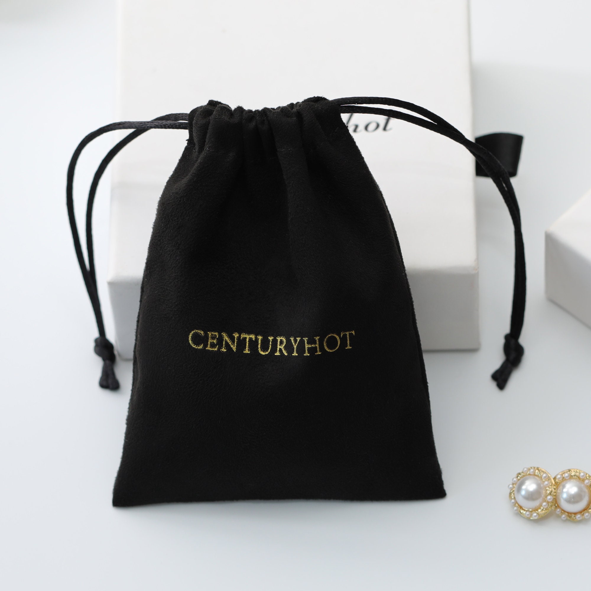 Small jewelry brands reduce inventory waste with 50 MOQ custom suede drawstring bags, fitting necklace-earring sets securely (from product introduction)