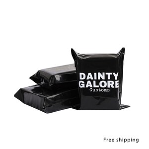 May include: Stack of three black poly mailers with the text "DAINTY GALORE Customs" printed in white on the front of the top mailer.