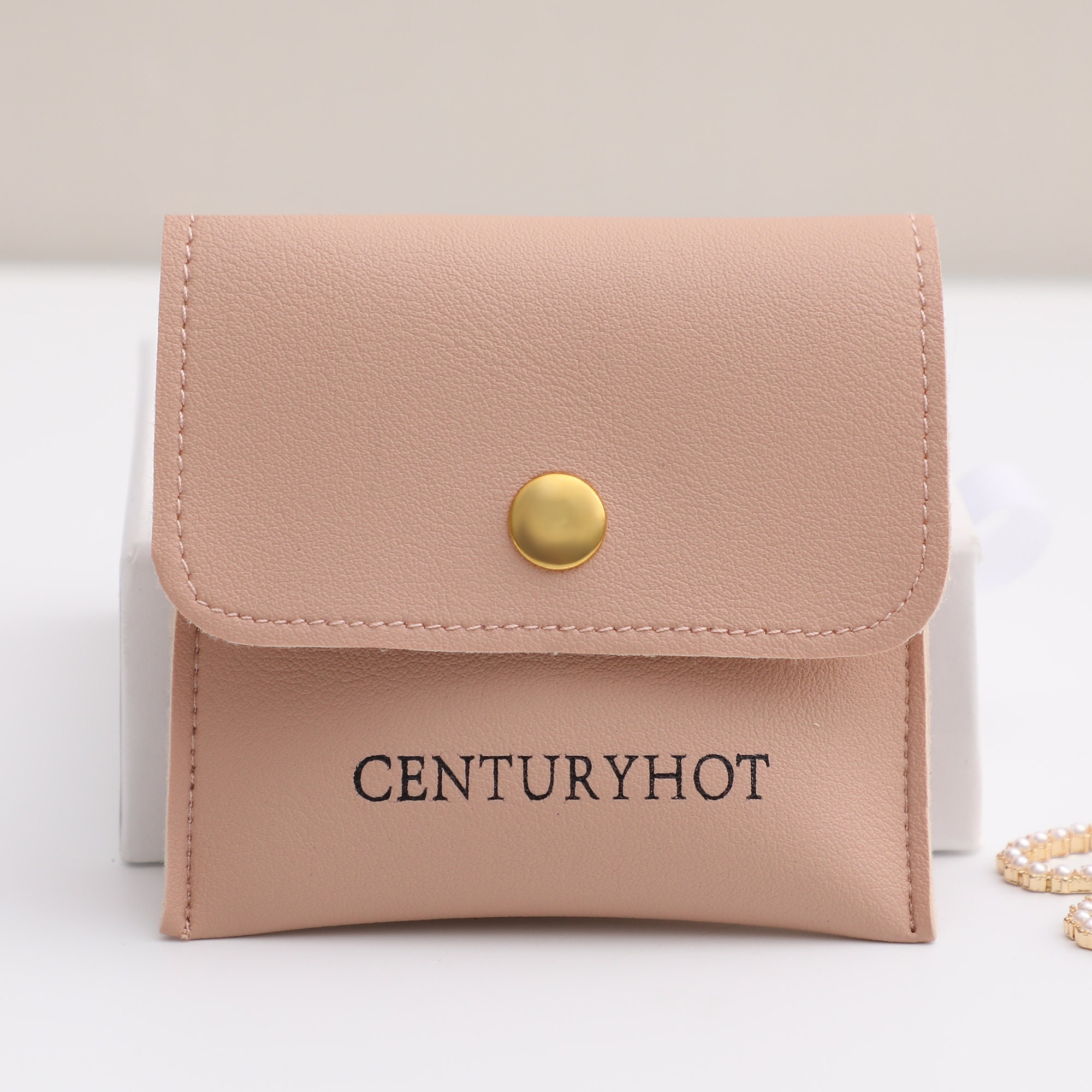 Custom logo snap flip leather bag with embossed branding for small jewelry brand packaging