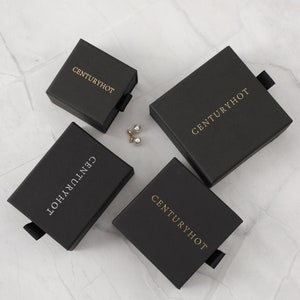 May include: Four black boxes with the text "Centuryhot" in gold lettering. The boxes have a pull tab on the side.