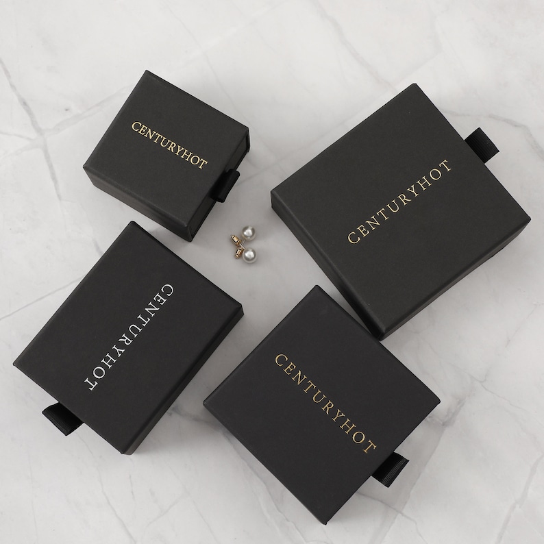 May include: Four black boxes with the text "Centuryhot" in gold lettering. The boxes have a pull tab on the side.
