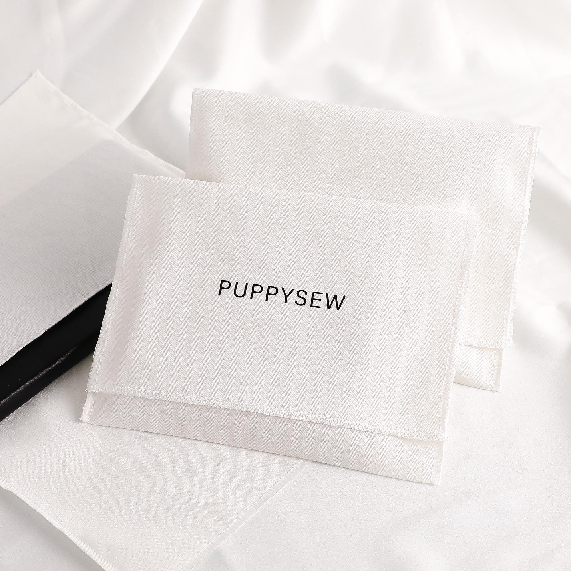 Custom logo on eco-friendly cotton envelope bag, demonstrating branding potential for small jewelry brands
