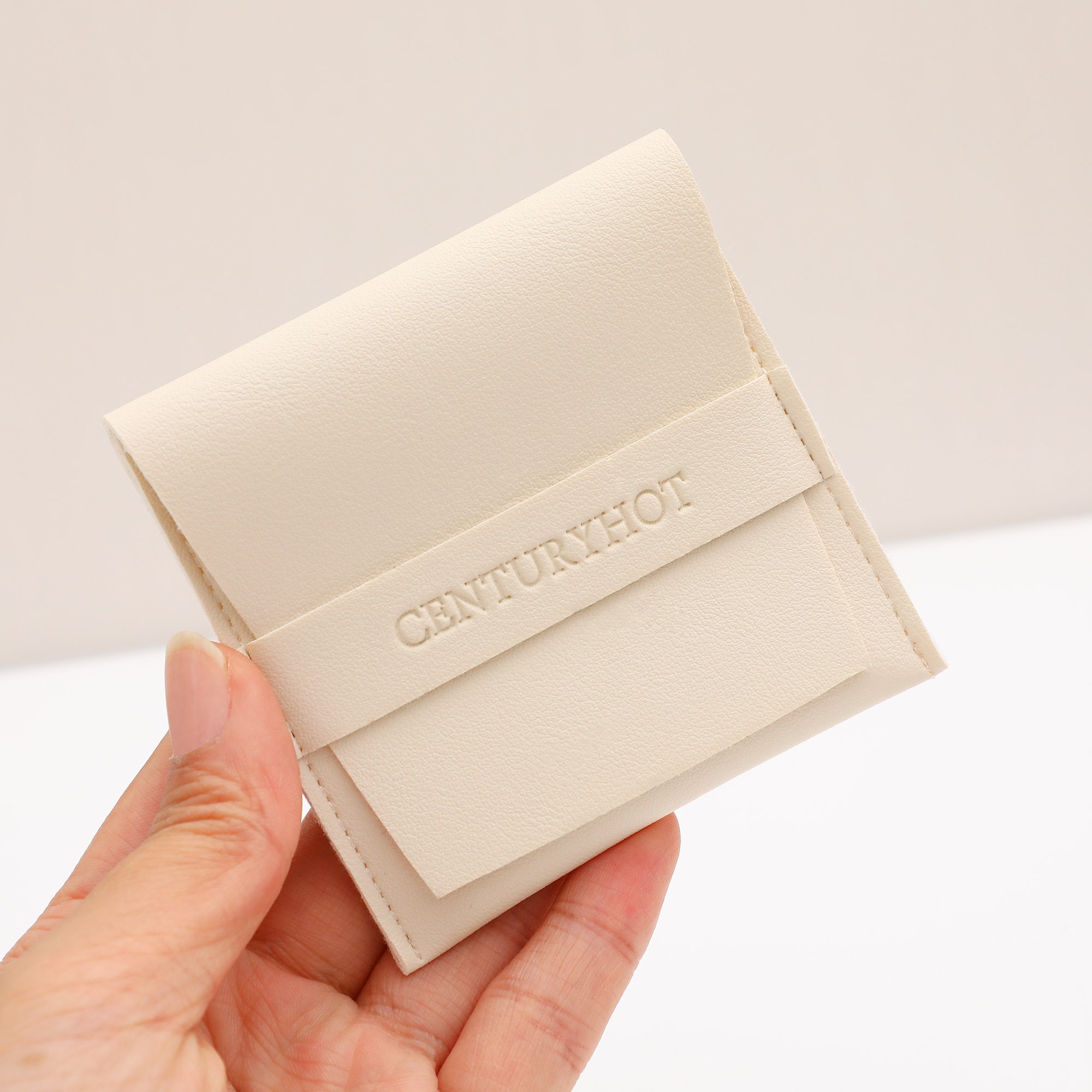 White PU Pouch with embossed custom logo, showcasing branding potential for jewelry businesses