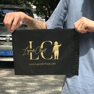 May include: Black mailing bag with gold lettering that reads "LC Legends Closet" and a website address "www.LegendsCloset.com". A small silhouette of a child is also included in the design.