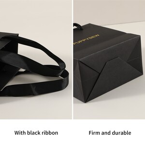 May include: Black paper gift bag with black ribbon handles and gold lettering that says "PUPPYSEW". The bag is firm and durable.