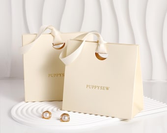 Bolsas de papel personalizadas con cinta beige, embalaje de lujo para boutiques, logotipo personalizado.