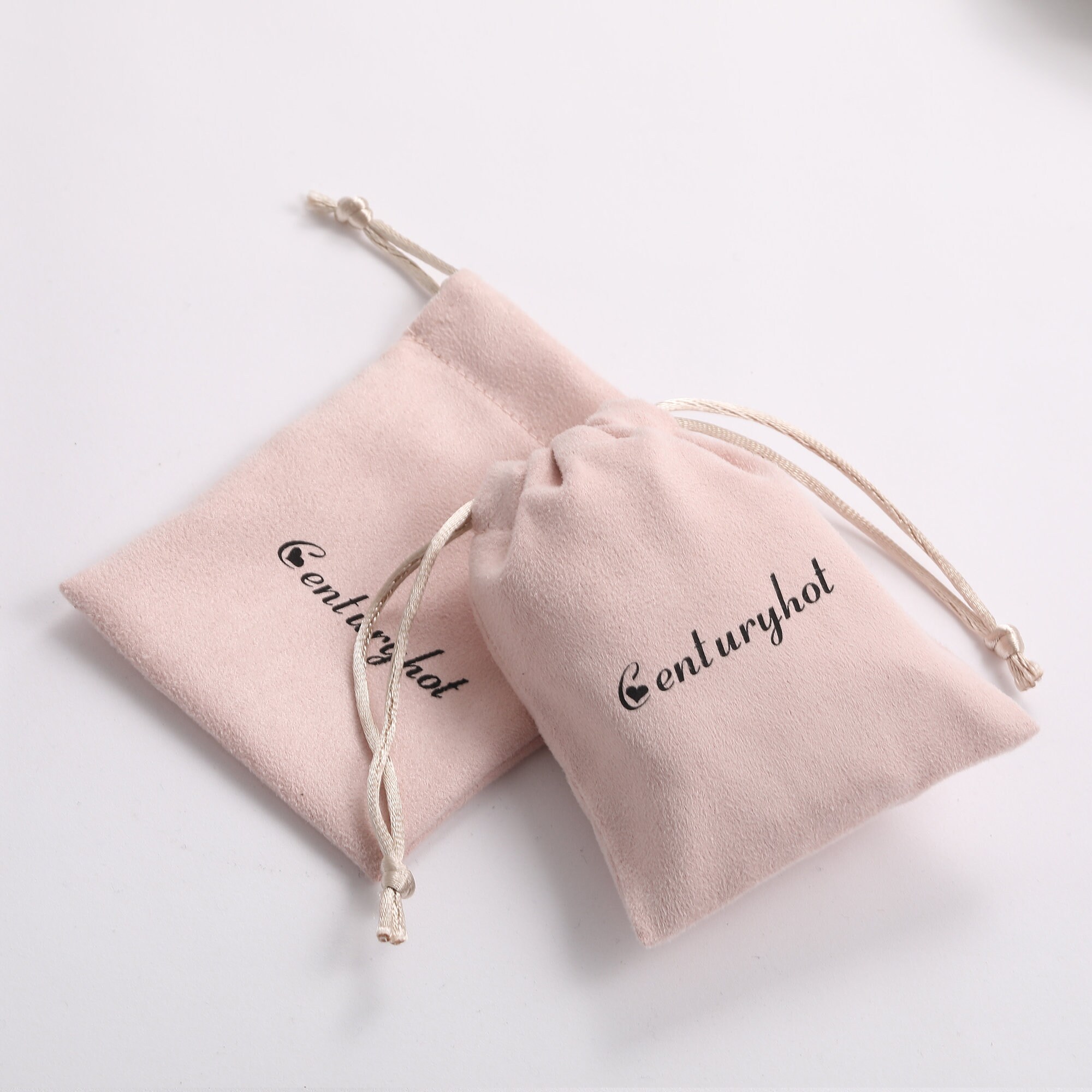 Pink Drawstring Jewelry Bags made of soft flannel to protect delicate jewelry, ideal for small brands needing reliable packaging