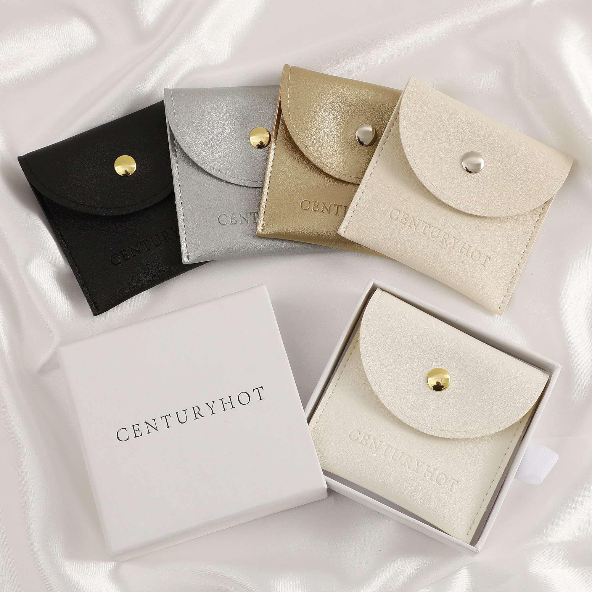 Cream faux leather pouch with smooth texture, ideal for protecting ring and necklace jewelry—key for choosing durable packaging
