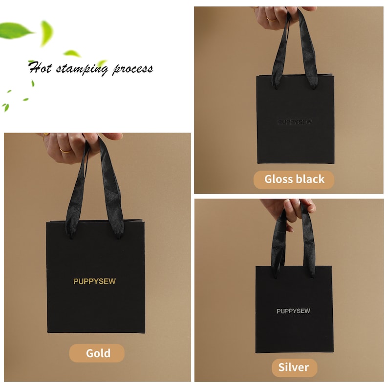 May include: Three black gift bags with black ribbon handles. The bags have the text "PUPPYSEW" printed in gold, silver, and gloss black.
