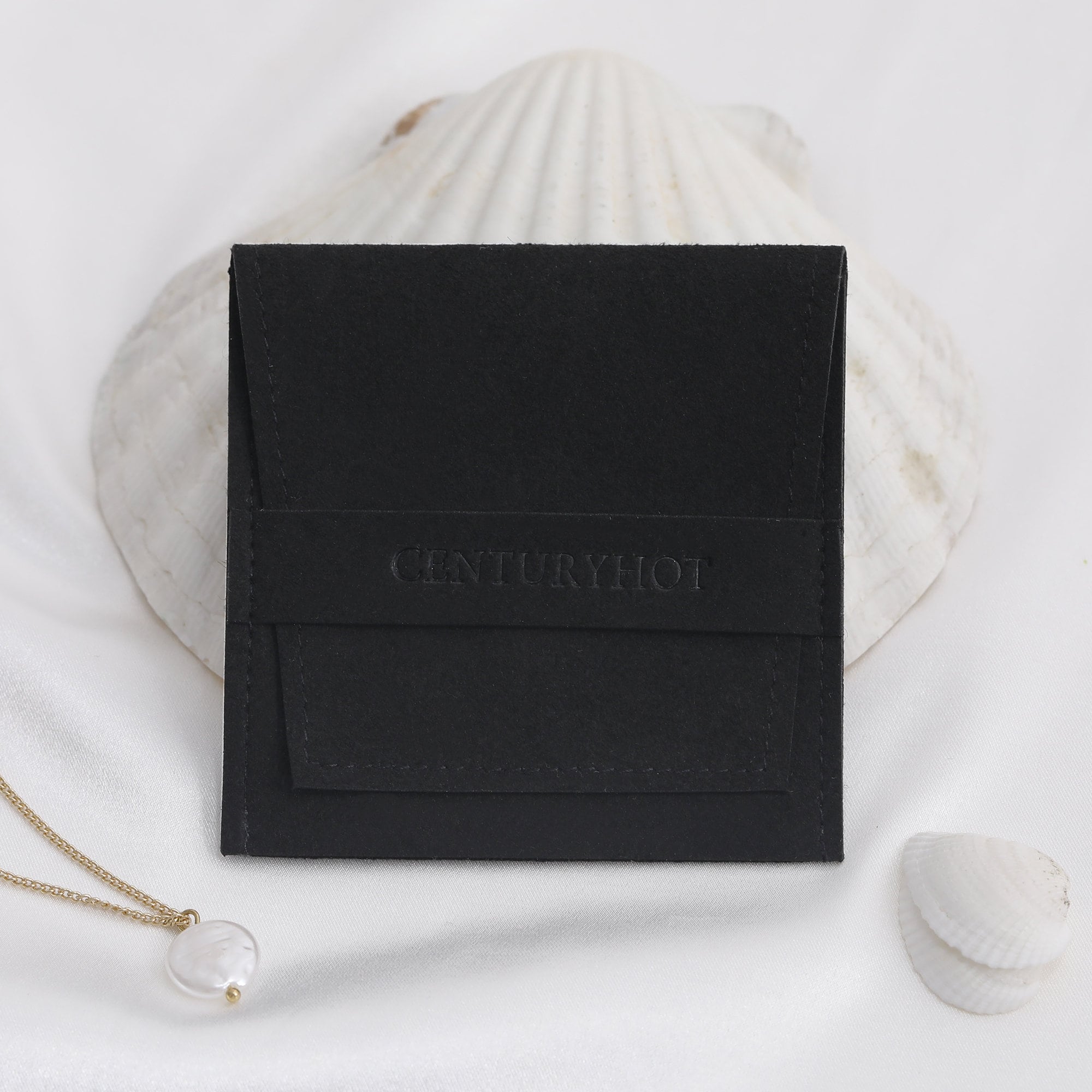 Multiple sizes of black recessed logo microfiber bags to fit rings, necklaces, and bracelets