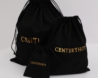 May include: Three black drawstring bags with gold lettering. The largest bag says "CENTURYHOT" and the two smaller bags say "CENTURYHOT".