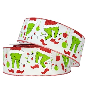 May include: White ribbon with a red trim and a repeating pattern of green Grinch legs wearing red boots and Santa hats, green ornaments, and red and white Christmas lights.