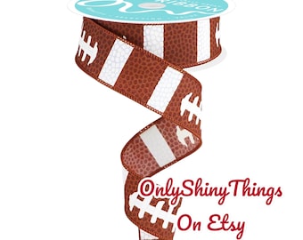 May include: A roll of brown and white football-themed ribbon. The ribbon features a repeating pattern of footballs with white stripes and laces. The spool has the text "R. Ribbon" on it, and the text "Only Shiny Things On Etsy" is on the ribbon.