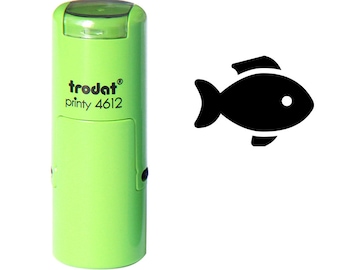 May include: A light green self-inking stamp with the text "trodat printy 4612". A black fish icon is to the right of the stamp. The fish icon has a white dot for an eye.