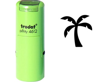 May include: A light green Trodat printy 4612 stamp with a black palm tree icon. The stamp is cylindrical with a rectangular window. The palm tree icon is to the right of the stamp.