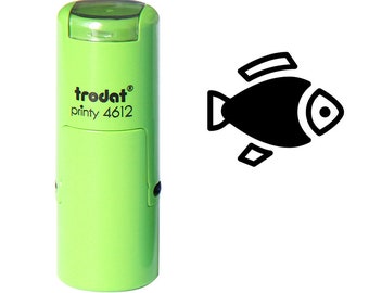 May include: A light green self-inking stamp with the text "trodat printy 4612". The stamp has a black fish icon next to it. The fish icon is a simple, stylized design.