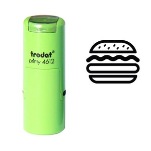 Puede incluir: Un sello Trodat printy 4612 verde claro con un icono de hamburguesa negro. El sello tiene un diseño rectangular con bordes redondeados. El icono de la hamburguesa es un contorno simple de una hamburguesa con pan, carne y aderezos.