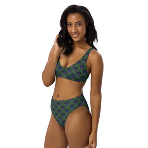 Peut inclure: Un bikini à taille haute vert et violet avec un motif géométrique. Le haut du bikini a un décolleté arrondi et des bretelles réglables. Le bas du bikini a une jambe haute.