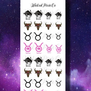 May include: A sheet of nail art stickers featuring a black and white Taurus zodiac sign with pink accents. The stickers are arranged in rows and include various designs, such as a bull's head, a bull's horns, and the Taurus symbol.