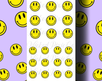 May include: A sheet of yellow smiley face nail decals on a light purple background. The decals are arranged in rows and columns, with the text "WickedPixieCo" at the top of the sheet.