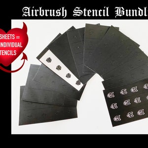 May include: A set of 12 sheets of black airbrush stencils, each sheet containing 12 individual stencils. The stencils feature a variety of designs, including skulls, dice, and other graphic elements. The text "12 SHEETS = 144 INDIVIDUAL STENCILS" is printed on a red heart with devil horns.