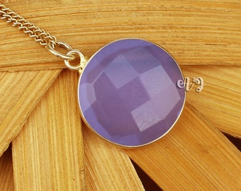 May include: A delicate gold chain necklace with a purple gemstone pendant. The pendant is a round, faceted stone with a light purple hue.