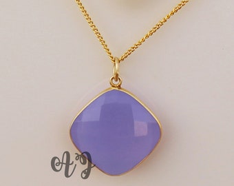 May include: A gold chain necklace with a square-shaped pendant featuring a light purple gemstone.